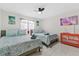 Serene bedroom with twin beds, bright linens, and a stylish cabinet, offering a relaxing retreat at 5812 Blossom Ave, Tampa, FL 33614