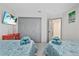 Inviting bedroom features two twin beds, closet space, and a mounted TV for relaxed comfort at 5812 Blossom Ave, Tampa, FL 33614