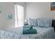 Cozy bedroom with window, bedside lamp, and coastal decorations at 5812 Blossom Ave, Tampa, FL 33614