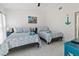 Bright bedroom has two beds, ceiling fan, and coastal decorations at 5812 Blossom Ave, Tampa, FL 33614