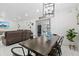 Inviting dining area adjacent to a living room, featuring modern decor and bright lighting at 5812 Blossom Ave, Tampa, FL 33614