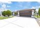 Home exterior showing concrete driveway and well-manicured lawn with shrubbery at 5812 Blossom Ave, Tampa, FL 33614