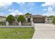 Charming single-story home has manicured landscaping and a secure fenced front yard at 5812 Blossom Ave, Tampa, FL 33614