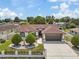 Charming single-story home with a well-maintained lawn, mature trees, and a brown roof at 5812 Blossom Ave, Tampa, FL 33614