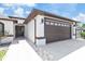 Close up of the home's exterior showing the front door, walkway and two car garage at 5812 Blossom Ave, Tampa, FL 33614