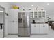 Spacious kitchen with stainless steel refrigerator and ample cabinet space, adjacent to a cozy living area at 5812 Blossom Ave, Tampa, FL 33614