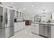 Stylish kitchen featuring stainless steel appliances and granite countertops that opens up to a comfortable living area at 5812 Blossom Ave, Tampa, FL 33614