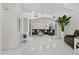 Spacious living room with tile floors, nautical decor, and a large leather sectional sofa at 5812 Blossom Ave, Tampa, FL 33614