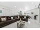 Open-concept living area featuring tile flooring, a large sectional sofa, and a dining space at 5812 Blossom Ave, Tampa, FL 33614