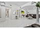 Open-concept living room with tile floors, neutral paint, and a large leather sectional sofa at 5812 Blossom Ave, Tampa, FL 33614