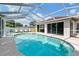 Inviting pool area featuring a sparkling pool, covered enclosure, and ample seating for relaxation at 5812 Blossom Ave, Tampa, FL 33614