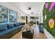 Spacious sunroom with cozy seating, a television, and outdoor views, perfect for relaxation at 5812 Blossom Ave, Tampa, FL 33614