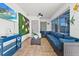 Cozy sunroom with tile floors, comfortable seating, and sliding glass doors to the outside at 5812 Blossom Ave, Tampa, FL 33614