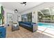 Relaxing sunroom offering pool views and easy access to a half bathroom at 5812 Blossom Ave, Tampa, FL 33614