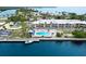 Aerial view of waterfront condos with a community pool, lush landscape, and boat access at 611 Destiny Dr, Ruskin, FL 33570