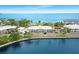 Scenic aerial view of waterfront condos with a parking lot and landscaped grounds at 611 Destiny Dr, Ruskin, FL 33570