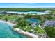 Beautiful waterfront view of tennis courts, and lounging area surrounded by mature trees at 611 Destiny Dr, Ruskin, FL 33570