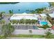 Aerial view of condos with pool, parking, mature palms, and professionally maintained landscaping at 611 Destiny Dr, Ruskin, FL 33570