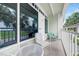 Private balcony with white metal railings, seating, and beautiful views of lush tropical landscaping at 611 Destiny Dr, Ruskin, FL 33570