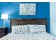 Well-lit bedroom with a queen-sized bed, stylish bedding, and a decorative wall print at 611 Destiny Dr, Ruskin, FL 33570