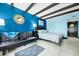 Comfortable and stylish bedroom with modern decor, futon couch and queen-size bed at 611 Destiny Dr, Ruskin, FL 33570