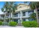 Beautiful condo building with multiple balconies surrounded by vibrant tropical foliage at 611 Destiny Dr, Ruskin, FL 33570