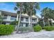 Inviting condo building exterior with charming balconies and lush tropical plants at 611 Destiny Dr, Ruskin, FL 33570