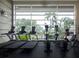 Modern gym with state-of-the-art equipment, featuring floor-to-ceiling windows and natural light at 611 Destiny Dr, Ruskin, FL 33570