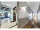 Well-lit hallway with wood floors leads to a bright, airy room with tile flooring and neutral decor at 611 Destiny Dr, Ruskin, FL 33570