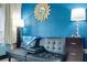 Cozy living area features a comfortable futon couch, accent wall and decorative mirror at 611 Destiny Dr, Ruskin, FL 33570