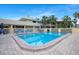 Beautiful community swimming pool with clear blue water, surrounded by lounge chairs and tropical landscaping at 611 Destiny Dr, Ruskin, FL 33570