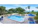 Community pool with lounge chairs and tables for outdoor relaxation at 611 Destiny Dr, Ruskin, FL 33570