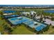 Aerial view showcasing tennis, pickleball and basketball courts within the community at 6127 Colmar Pl, Apollo Beach, FL 33572
