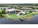 Aerial view showcasing the community clubhouse, pool, lake, and surrounding homes at 6127 Colmar Pl, Apollo Beach, FL 33572