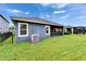 Exterior shot showcasing the backyard, complete with a screened patio, a well-manicured lawn, and tidy landscaping at 6127 Colmar Pl, Apollo Beach, FL 33572