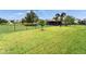Expansive backyard with a lush lawn and secure black metal fencing at 6127 Colmar Pl, Apollo Beach, FL 33572