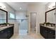 Bathroom featuring dual sinks, vanity, and a spacious glass shower at 6127 Colmar Pl, Apollo Beach, FL 33572