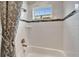 Close up of a shower-tub combo with tile walls, a window, and a shower curtain at 6127 Colmar Pl, Apollo Beach, FL 33572