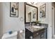 Bathroom featuring a granite vanity, a decorative mirror, and nautical wall art at 6127 Colmar Pl, Apollo Beach, FL 33572