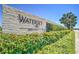 Elegant community entrance sign with lush landscaping and a clear blue sky overhead at 6127 Colmar Pl, Apollo Beach, FL 33572