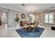 Dining room with a dark wood table, six chairs, area rug, and accent wall at 6127 Colmar Pl, Apollo Beach, FL 33572