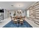 Open dining room features a dark wood table with six chairs, area rug, and accent wall at 6127 Colmar Pl, Apollo Beach, FL 33572