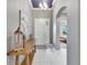 Bright foyer with tile floors, console table, and elegant light fixture at 6127 Colmar Pl, Apollo Beach, FL 33572