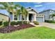 Charming single-Gathering home with well-manicured lawn and tropical landscaping at 6127 Colmar Pl, Apollo Beach, FL 33572