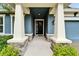 Inviting front porch with stone accents and neutral color palette at 6127 Colmar Pl, Apollo Beach, FL 33572