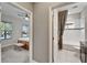 Hallway view of a bedroom and bathroom featuring tile floors and a shower with a tub at 6127 Colmar Pl, Apollo Beach, FL 33572