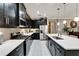 Well-appointed kitchen with black cabinetry, stainless steel appliances, and a central island for food preparation at 6127 Colmar Pl, Apollo Beach, FL 33572