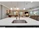 Bright kitchen island view showcasing the dining and living areas, offering a seamless flow for entertaining at 6127 Colmar Pl, Apollo Beach, FL 33572