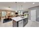 Open-concept kitchen with a spacious island, seamlessly connecting to the dining and living areas at 6127 Colmar Pl, Apollo Beach, FL 33572