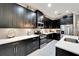 Contemporary kitchen featuring dark cabinets, stainless steel appliances, and ample countertop space at 6127 Colmar Pl, Apollo Beach, FL 33572